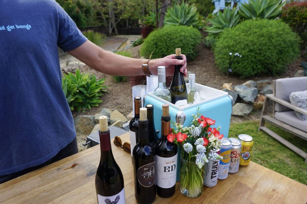 Bottles and drinkware set out on a bar table