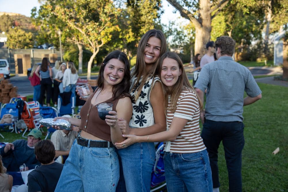 Three friends with margaritas at golden hour